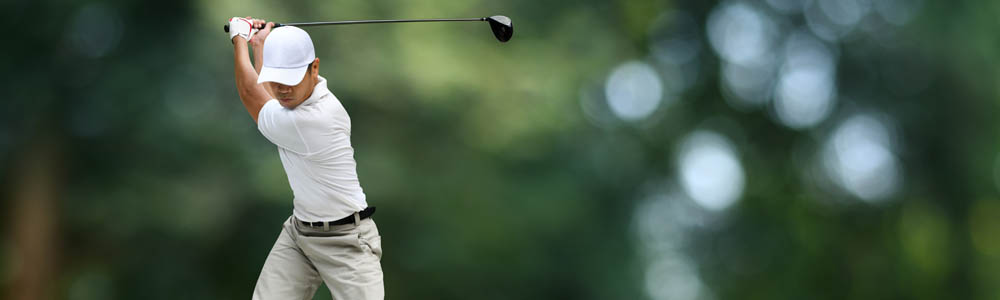Man preparing to drive a ball off the golf tee